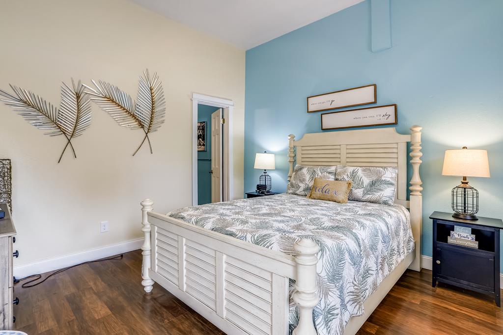 Sink into coastal serenity in your peaceful bedroom, where soothing blues and botanical touches create the perfect backdrop for dreamy vacation mornings and restful nights.