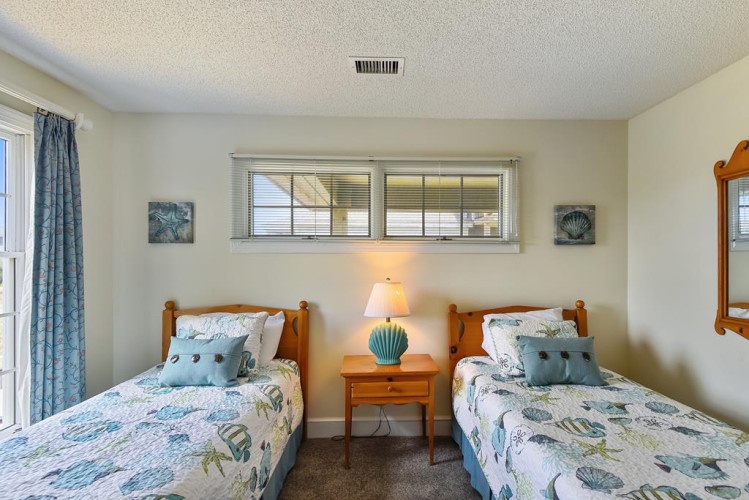Drift off in this charming twin bedroom with coastal décor and soft linens that invite restful nights. Wake refreshed, ready for your next adventure.