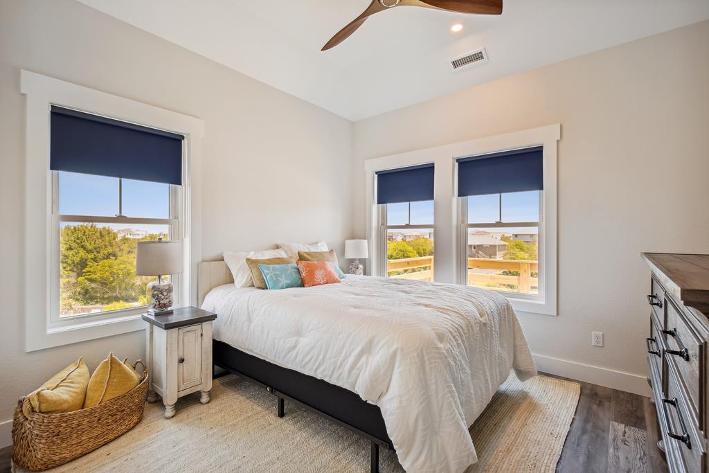 Wake up to natural light streaming through three windows, offering peaceful neighborhood views. Your inviting bed and cozy touches make this bright, airy bedroom the perfect retreat after exploring nearby attractions.