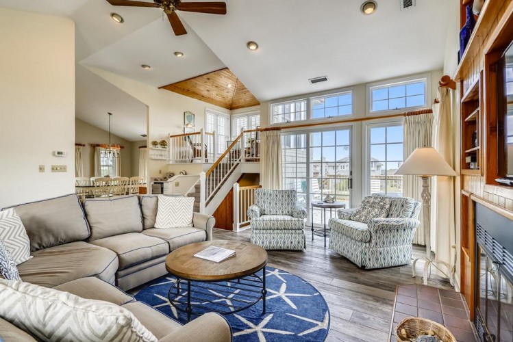 Relax in your spacious living room with soaring ceilings, abundant natural light, and coastal charm. Sink into comfortable seating while you plan your getaway adventures.