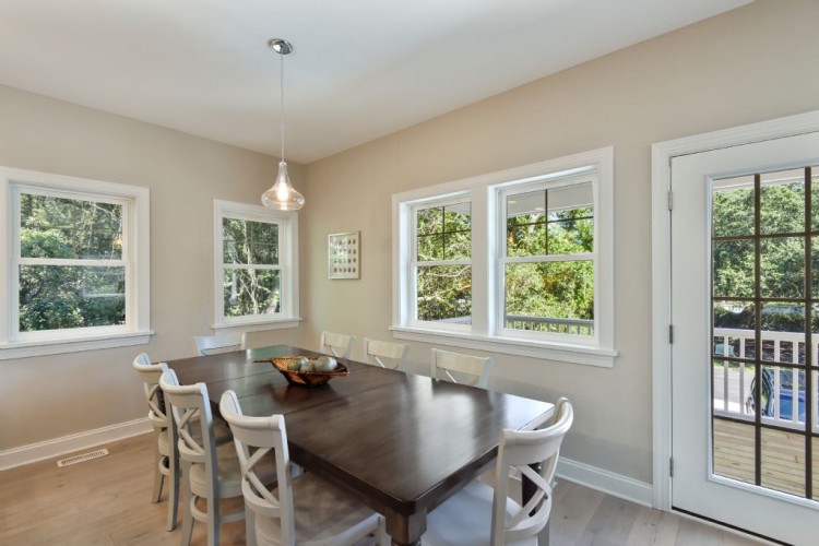 Picture yourself gathered around this inviting table with family, enjoying home-cooked meals in a bright, airy space that welcomes natural light from every angle.