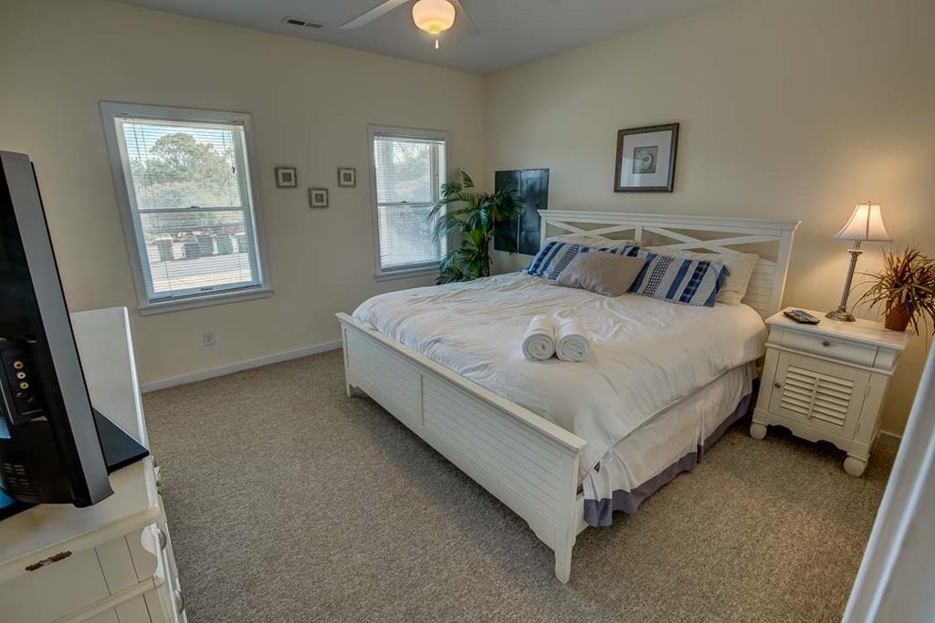 Sink into soft linens and coastal calm in your serene bedroom retreat. Bright windows, tasteful décor, and plush towels await your arrival for restful nights by the shore.