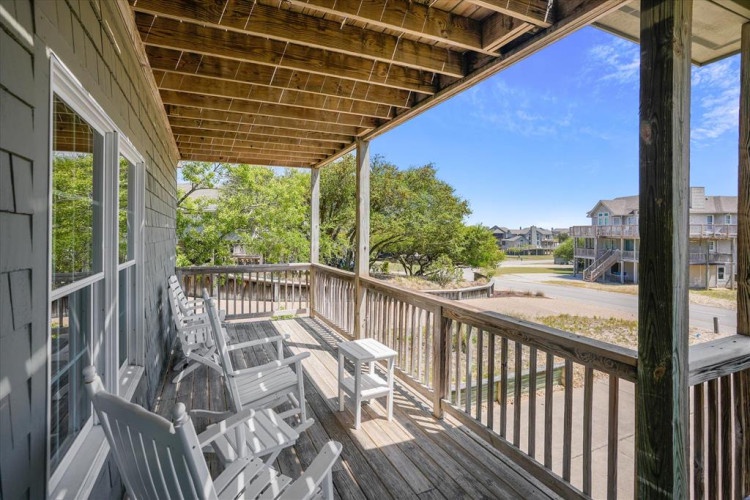Unwind in your private balcony oasis, where comfortable seating invites you to soak in peaceful neighborhood views and ocean breezes under an open sky.