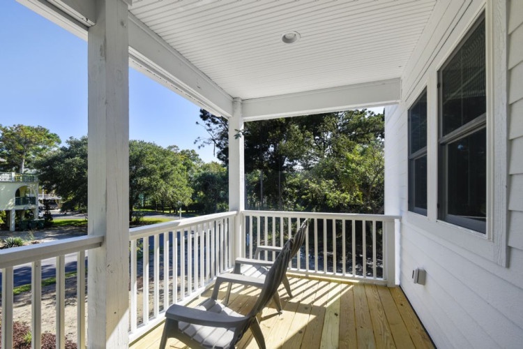 Step onto your private covered porch and settle into this peaceful spot, where gentle breezes and the surrounding greenery create your perfect morning coffee retreat or evening unwind.