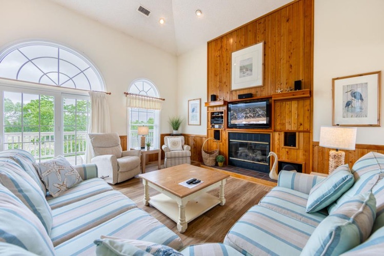 Step into your bright living room with vaulted ceilings, cozy fireplace, and plenty of space to unwind after a day of adventure.