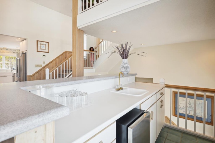 This open kitchen connects seamlessly with the living spaces, featuring sleek countertops and modern appliances to make meal prep a breeze during your stay.