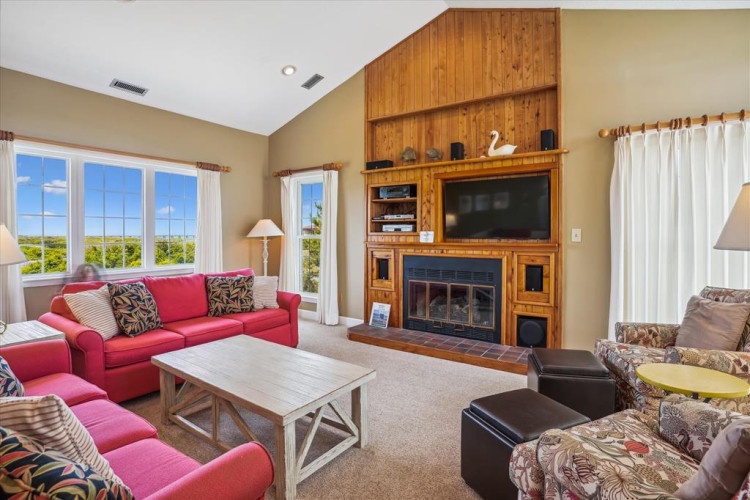 Relax in your spacious living room with vaulted ceilings, cozy fireplace, and sweeping landscape views. Sink into plush seating, enjoy your favorite shows, and unwind in comfort.