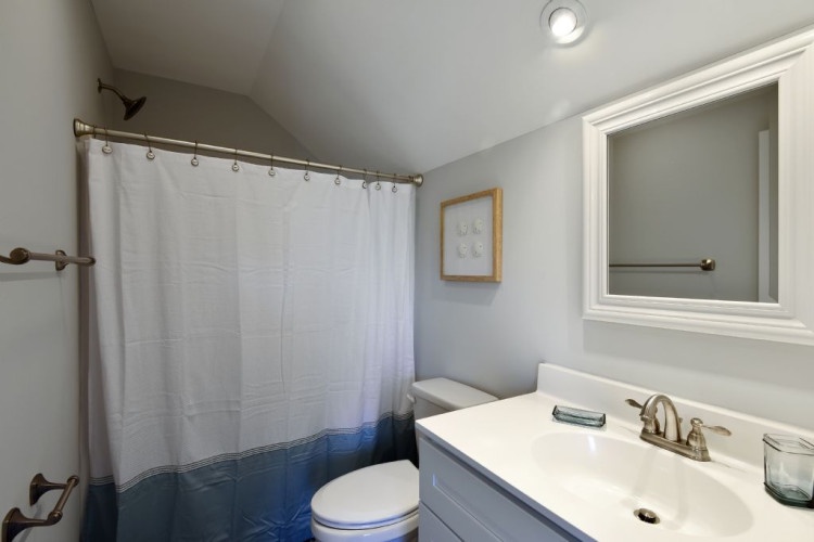 Step into your clean, modern bathroom with crisp blue and white details, where fresh towels and a bright vanity await after a relaxing day exploring the area.