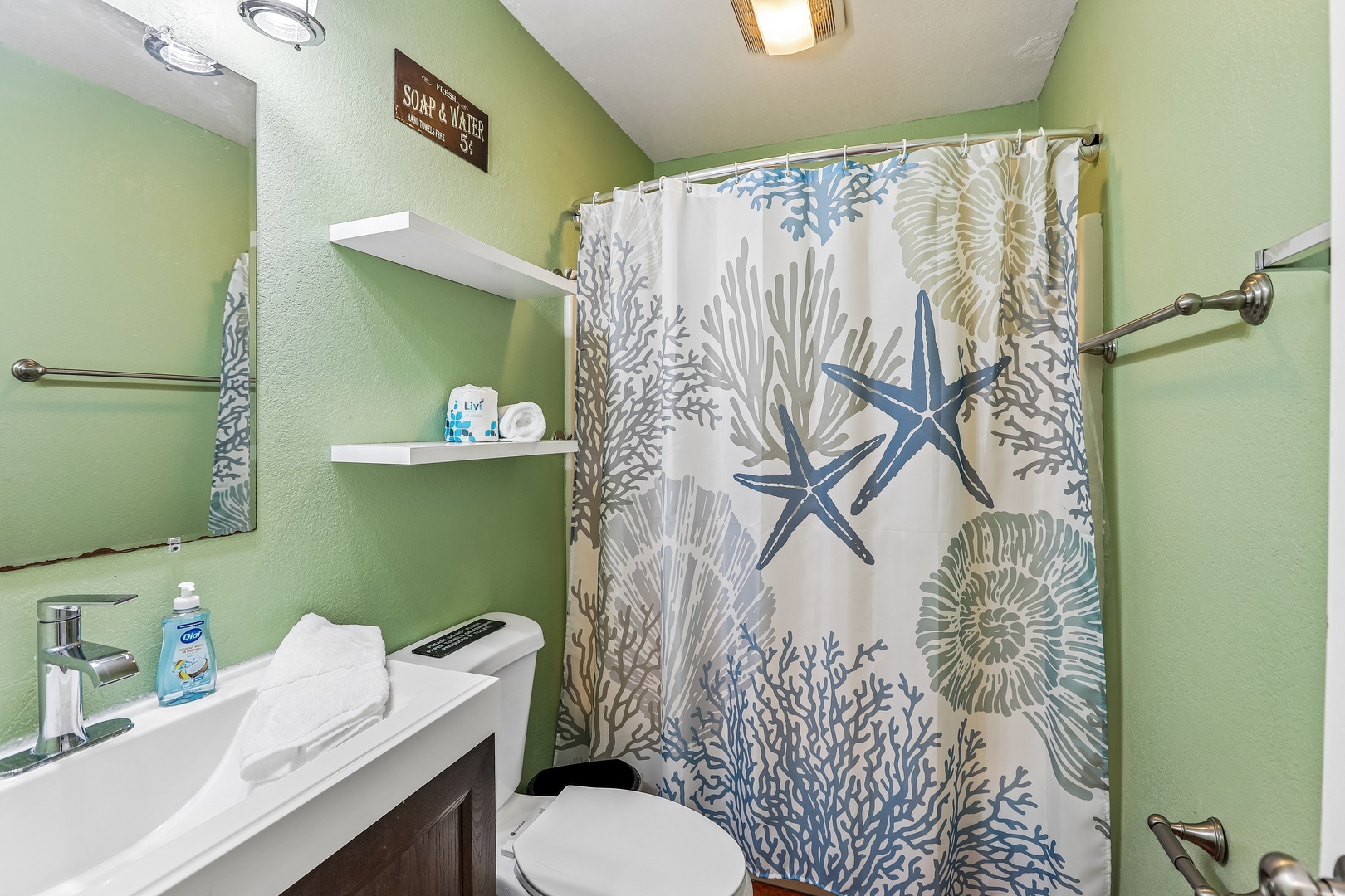 Refresh in your coastal-inspired bathroom with crisp linens and soothing seafoam walls. The thoughtful layout and cheerful décor make every morning feel like a beach getaway.