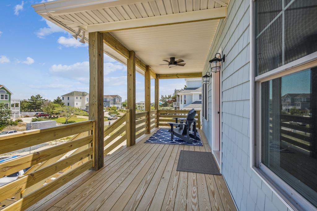 The covered porch offers your perfect spot to sip morning coffee or unwind after exploring the neighborhood, with comfortable seating and a gentle breeze overhead.