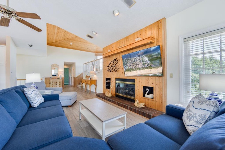 Sink into plush blue couches and unwind in front of your fireplace after a day of adventures. Natural wood accents warm the space, while vaulted ceilings and open design create an airy, inviting retreat for your group.