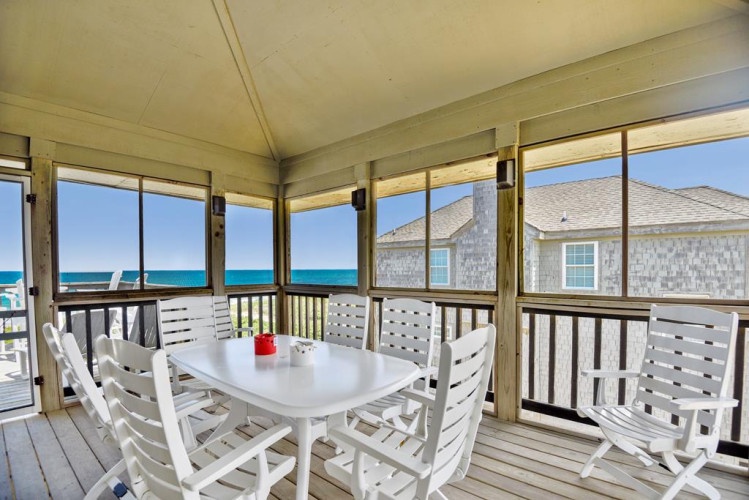 Your private screened porch overlooks the sparkling turquoise ocean, where you can dine with the sea breeze and watch the waves roll in—a peaceful retreat for morning coffee or evening meals.