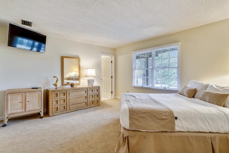 Unwind in your serene bedroom with plush bedding, natural light, and a mounted TV for your favorite shows. Your peaceful retreat awaits.