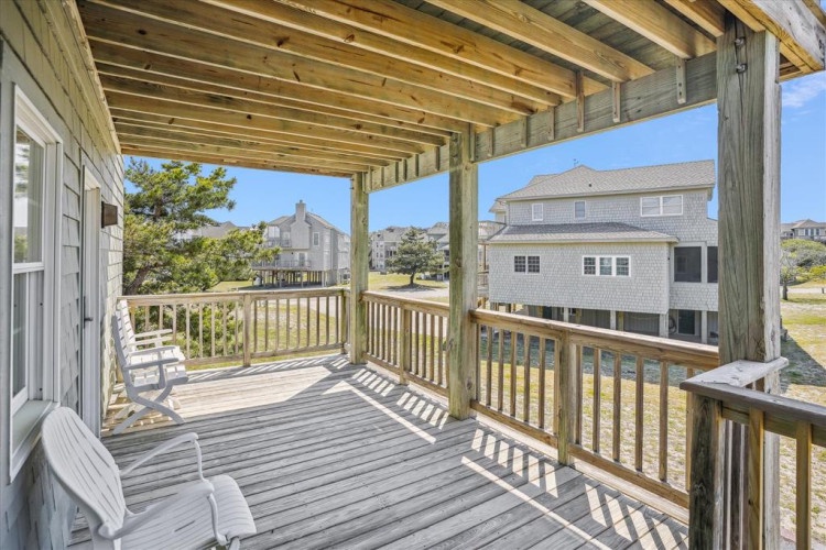 Relax on your covered deck with coastal breezes and views of the surrounding neighborhood—perfect for morning coffee or sunset evenings.
