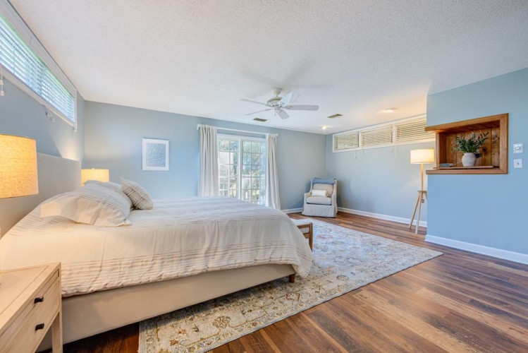 Unwind in your serene retreat with soft blue walls, plush bedding, and warm hardwood floors that invite you to kick off your shoes and truly relax.