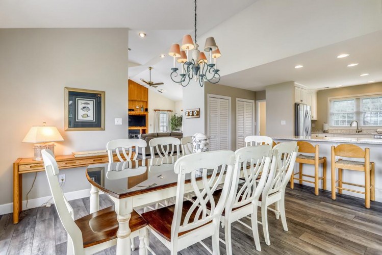 Gather around this elegant dining table that flows into your open-concept kitchen—perfect for sharing stories over meals with loved ones in a bright, welcoming space.