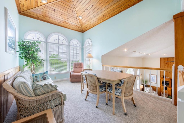 You'll love relaxing under the vaulted wood ceiling in this bright, airy space filled with natural light and coastal charm.