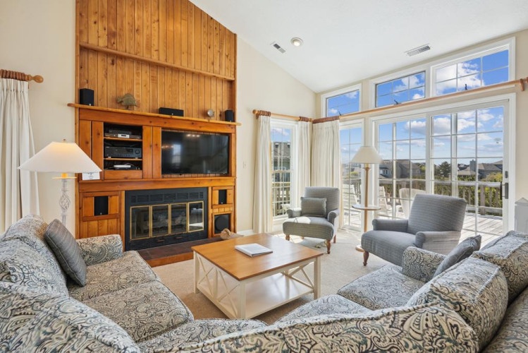 Curl up in your cozy living room with a fireplace, big-screen TV, and panoramic windows framing serene views—your perfect retreat after a day of adventure.