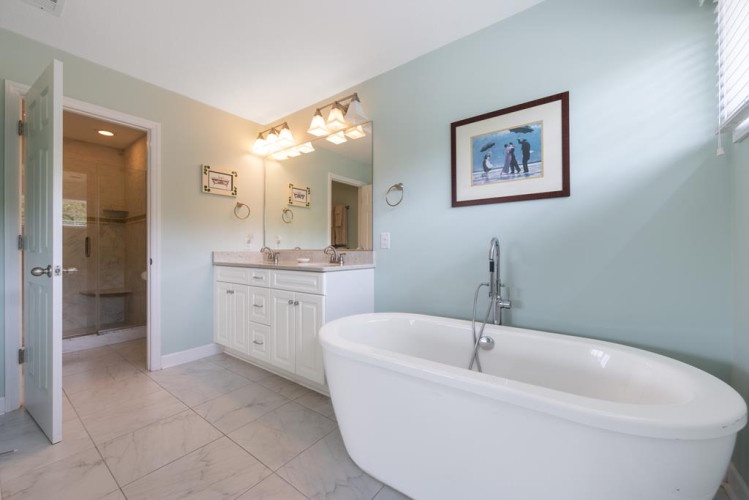 Sink into this serene soaking tub after a day of exploring. Soft lighting, a dual vanity, and calming coastal tones create your personal spa retreat.