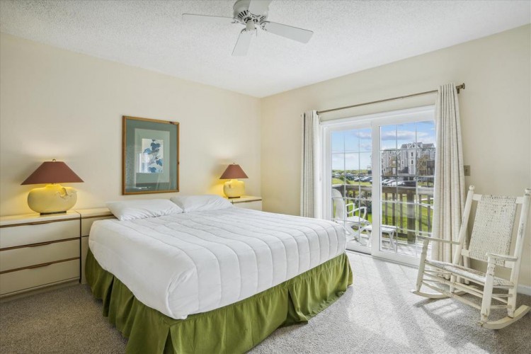 Wake up to sunlight streaming through your private balcony doors, where a gentle breeze and peaceful water views greet you each morning in your serene coastal bedroom retreat.