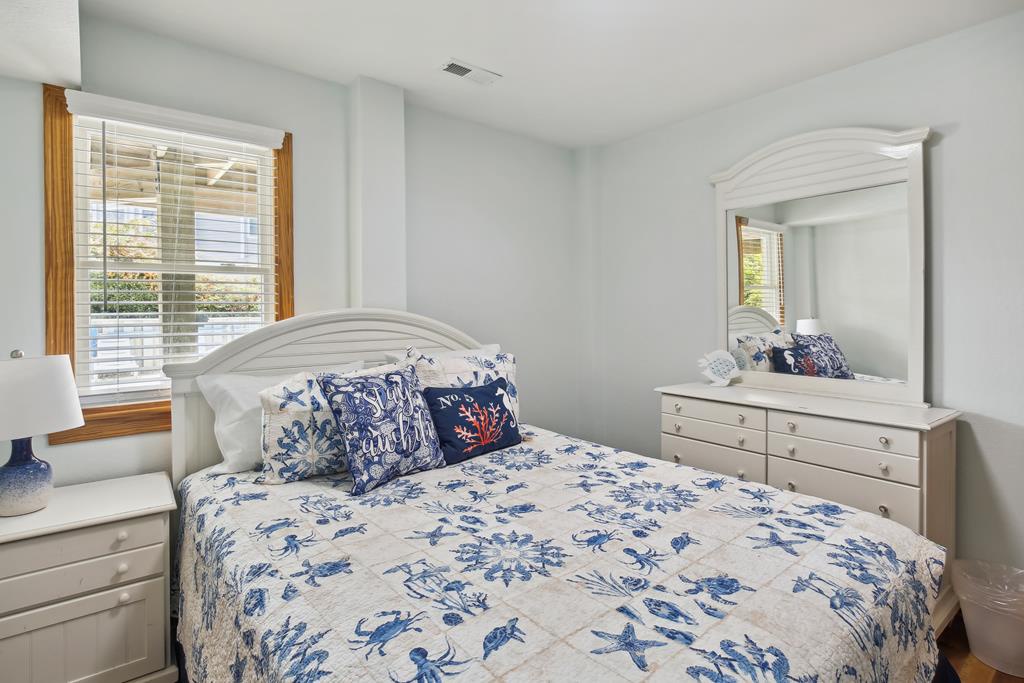 Slip into crisp coastal comfort in your serene bedroom, with soft linens, charming nautical decor, and natural light through plantation shutters.