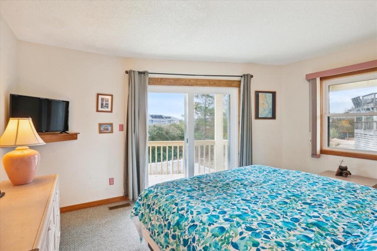 Wake up to natural light and fresh air in this peaceful bedroom. Your private balcony offers a serene spot to start your mornings with coffee or unwind after a day of exploring the coast.