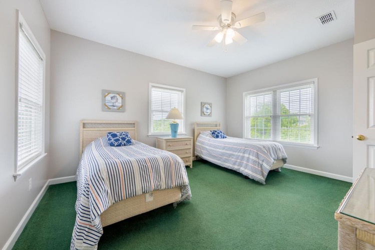 Step into your peaceful twin bedroom, where soft natural light and coastal touches create the perfect retreat for restful nights and lazy mornings.