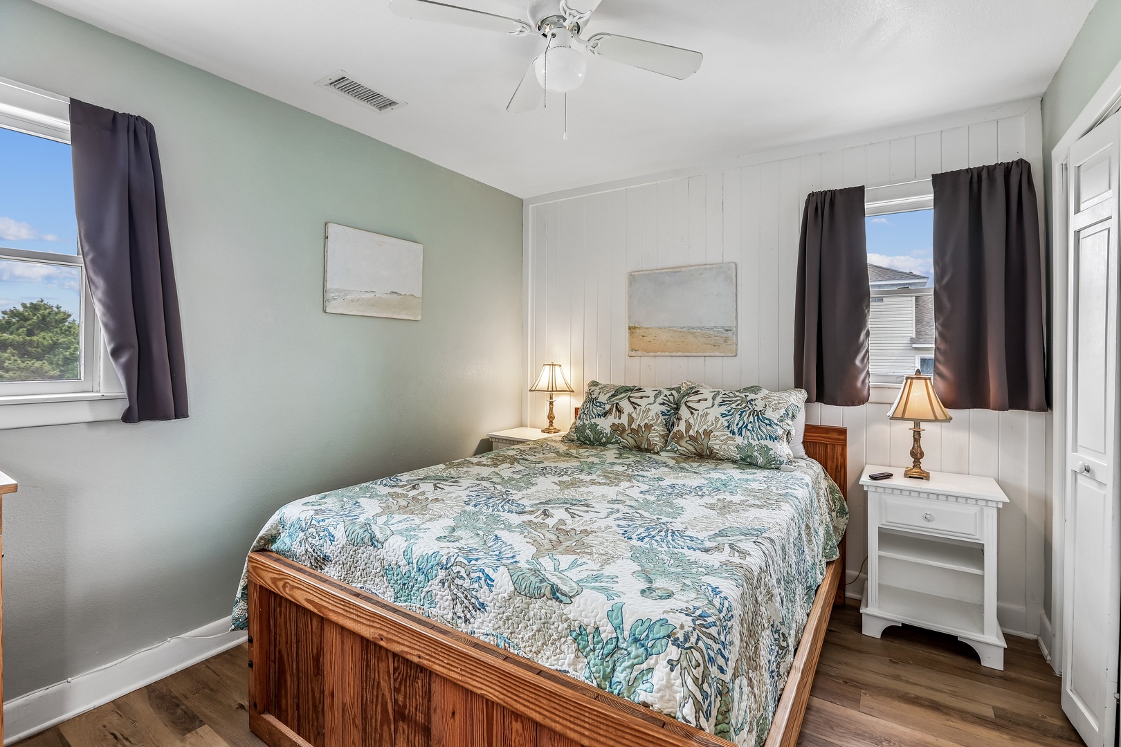 Drift off in your peaceful bedroom, where soft coastal colors and a gentle ceiling fan create the perfect retreat after your beach adventures.