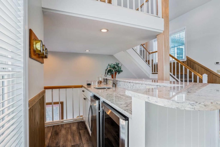 Sunlight pours into this open, airy space with gleaming marble countertops and warm wood accents inviting you to settle in and feel at home.