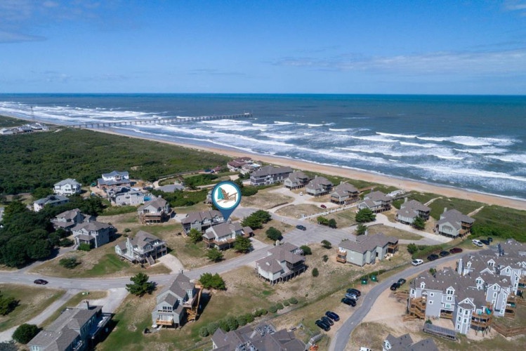 Oceanfront neighborhood with direct beach access, nestled between lush greenery and rolling Atlantic waves—a peaceful coastal escape.
