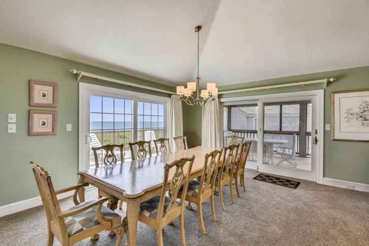 Gather for meals with scenic ocean views streaming through the windows—your coastal retreat awaits just steps away.
