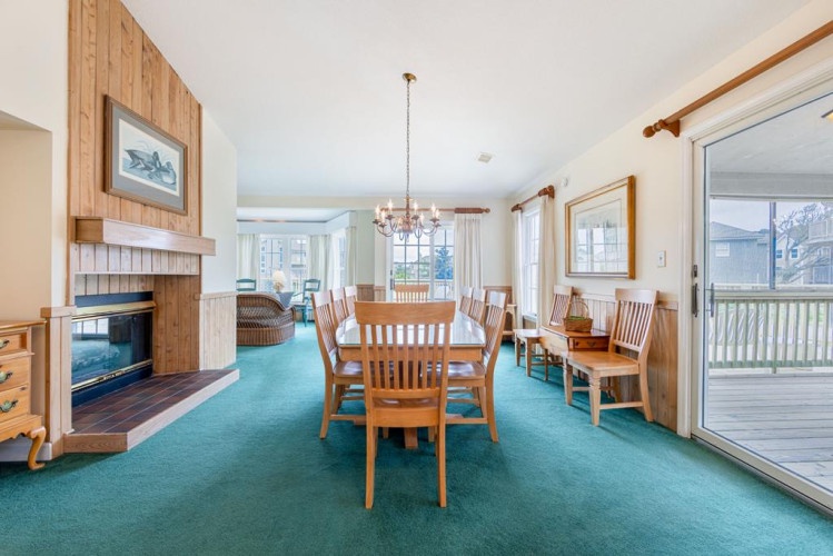 Gather around the dining table for family meals, enjoy the cozy fireplace, or step out onto your private deck—this open living space invites relaxation and togetherness.