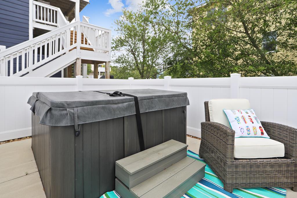 Your private patio features a hot tub, perfect for unwinding after a day of exploring. Settle into cozy seating under open skies, surrounded by trees and peaceful charm.
