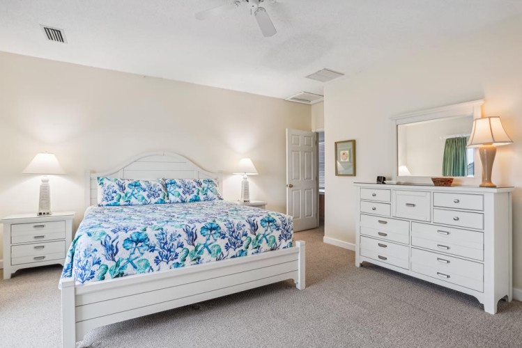 Slip into crisp sheets and a serene space styled just for you. The dresser and nightstands give you plenty of room to settle in, while the ceiling fan keeps you cool.