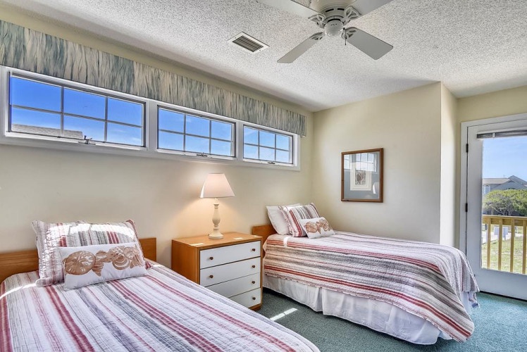 Unwind in your bright bedroom with two comfy beds, gentle breezes from the ceiling fan, and scenic views that make you feel instantly at home.