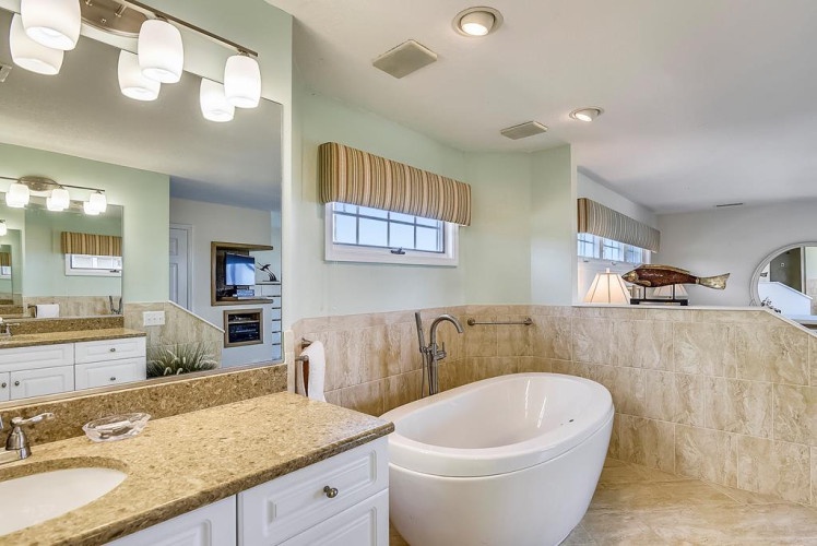 Slip into your luxurious soaking tub and let your worries melt away in this spa-inspired retreat, complete with elegant finishes and soft ambient lighting.