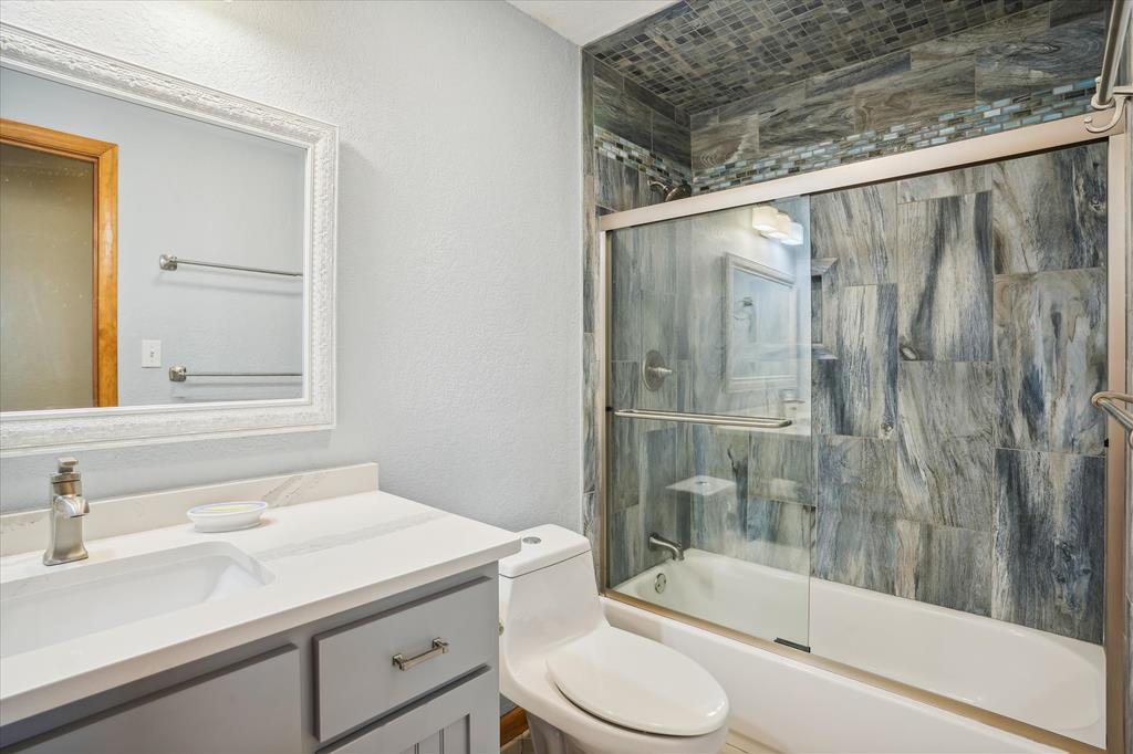 Refresh in this stylish bathroom with a walk-in shower featuring modern wood-look tile, clean lines, and all the essentials for your comfort.