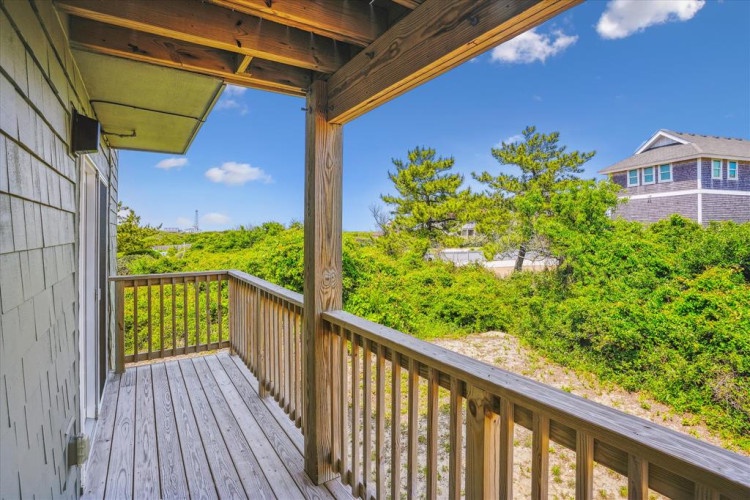 Step onto your private balcony and breathe in the fresh coastal air while gazing at the lush greenery and neighboring homes. This peaceful spot invites you to unwind with morning coffee or evening sunsets.
