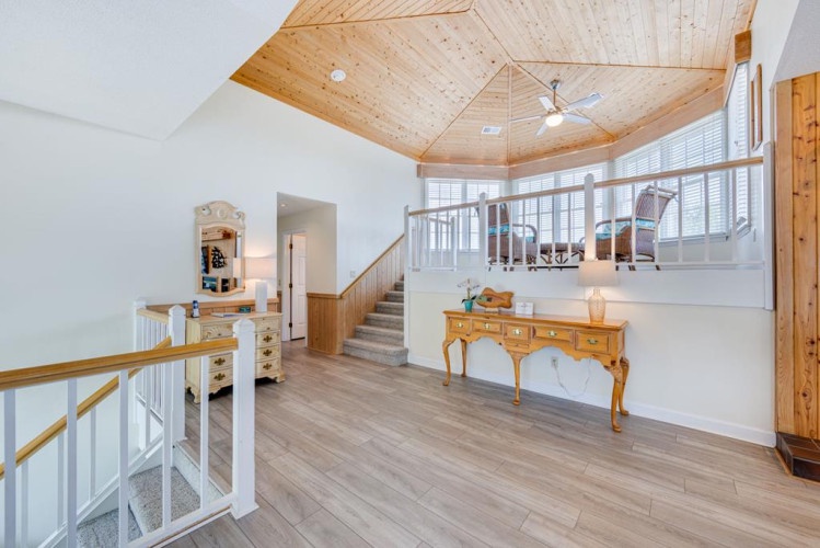 Step into your bright, open loft with soaring wood ceilings and scenic views. A cozy reading nook awaits upstairs, while the airy layout invites you to unwind in comfort.