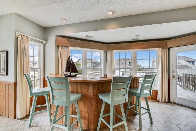 Gather around the high-top table, soak in the natural light, and enjoy your morning coffee with scenic views just beyond the windows.