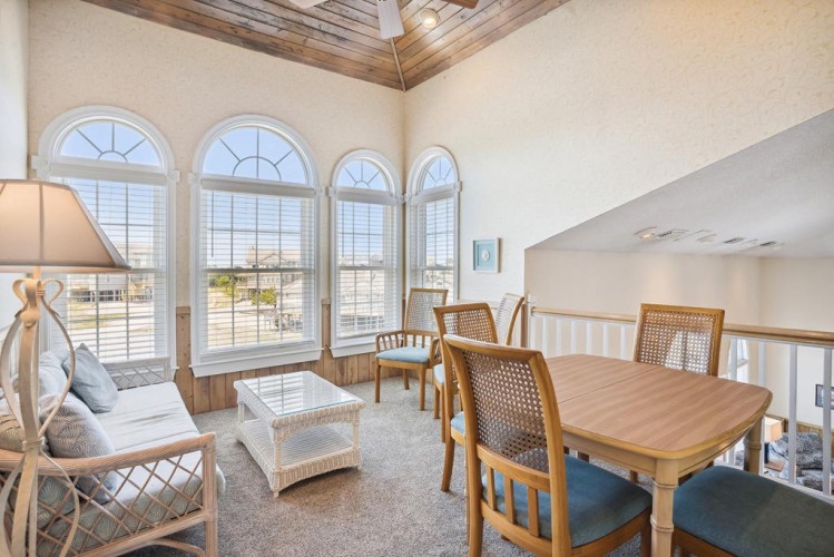 Light floods through elegant arched windows, illuminating your inviting dining and lounge space—perfect for gathering with loved ones or enjoying peaceful moments.