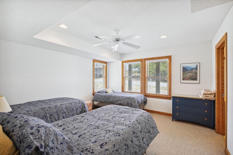 Drift off in your peaceful retreat with three plush beds, soft natural light, and a ceiling fan to keep you comfortable all night long.