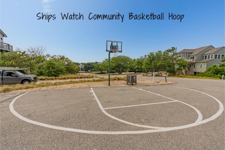 The community basketball court offers an inviting spot for friendly competition and active fun, surrounded by mature trees and coastal charm in the Ships Watch neighborhood.