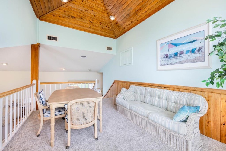 Gather around this inviting loft space where your group can enjoy meals or game nights under a beautiful vaulted wood ceiling. The coastal charm and bright airy feel make it perfect for unwinding together.