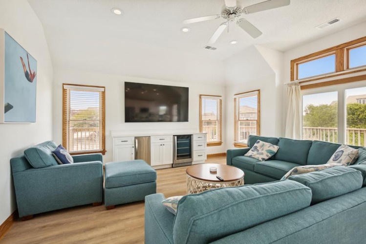 Sink into these plush sofas as you gather with loved ones in your bright, airy living room with high ceilings, entertainment center, and scenic views.