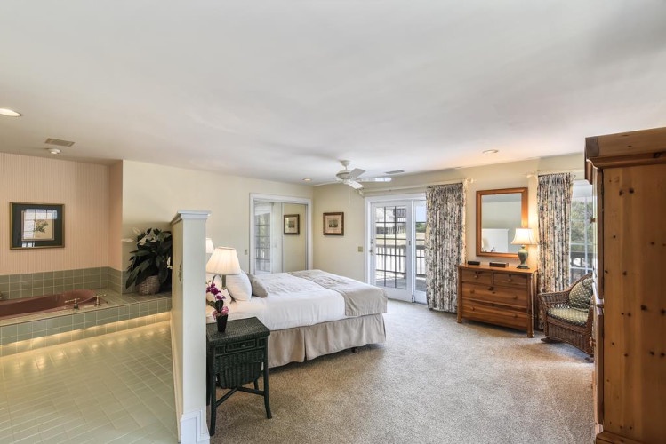 Step into your private retreat, where a plush bed awaits beneath soft lighting, and French doors open to your own balcony for morning coffee or evening stargazing.