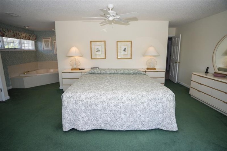 Your spacious master bedroom offers plush carpeting, soothing neutral tones, and elegant lighting, with a private jacuzzi tub creating the perfect retreat after a day of exploring.