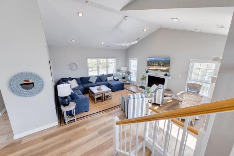 Step into your coastal retreat where vaulted ceilings, abundant natural light, and nautical-inspired décor create a breezy, inviting atmosphere perfect for unwinding after a day at the beach.