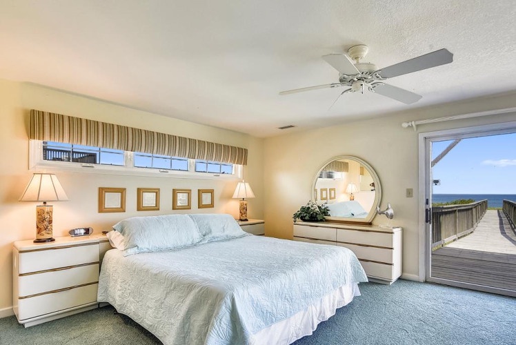 Wake up to stunning ocean views from your private balcony. This serene bedroom offers comfort and direct access to the beach boardwalk for your morning stroll.