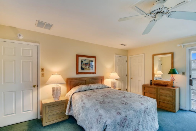 Relax in your serene bedroom with soft lighting, coastal decor, and soothing colors that invite peaceful nights. A ceiling fan keeps you comfortable year-round while bedside lamps set the perfect mood.